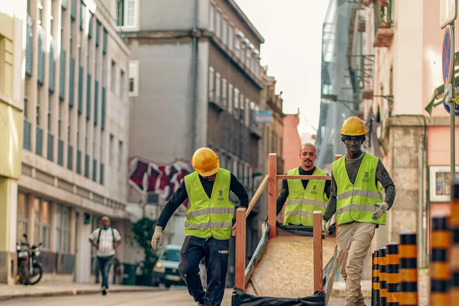 Equipe CLT da Shark Construtora carregando fôrma em obra predial em Curitiba